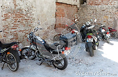 Motorbikes parked near ruins