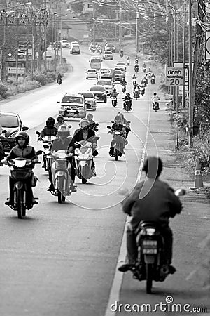 Motorcycle going opposite way on busy street in Phuket