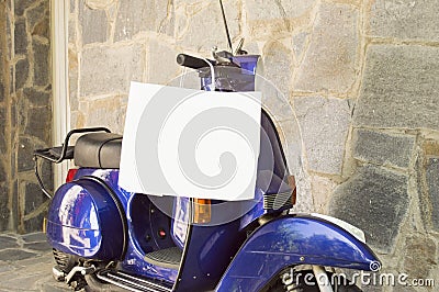 Motorcycle parked with a shopping bag hanging