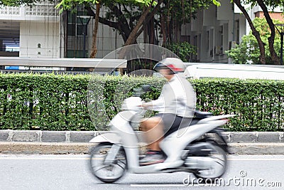 Motorcycle rider in the city traffic in motion blur