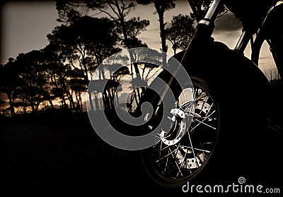 Motorcycle wheel on sunset