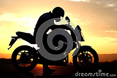 Motorcyclist silhouette at the sunset