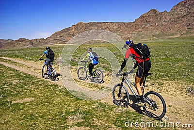 Mountain bikers on old road in steppe