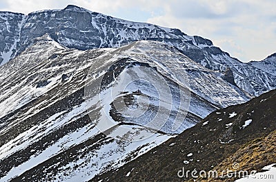 Mountain cliffs with melting snow