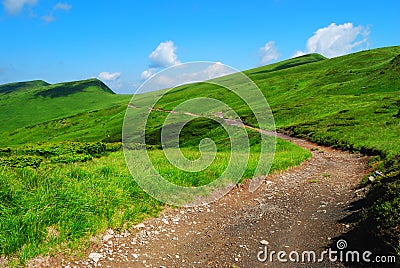 Mountain road to remote green hills