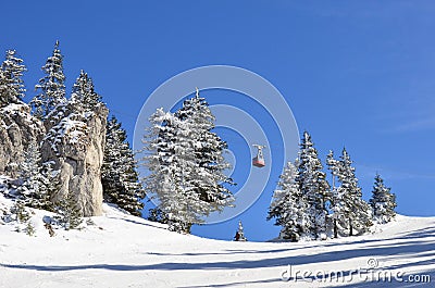 Mountain ski slope, skier and cable car