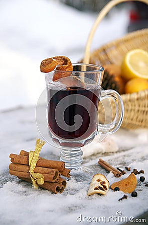 Mulled red wine in a glass mug outdoor in winter