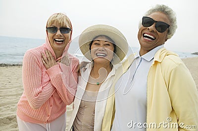 Multiethnic Female Friends Laughing On Beach