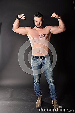 Muscle young man posing in studio