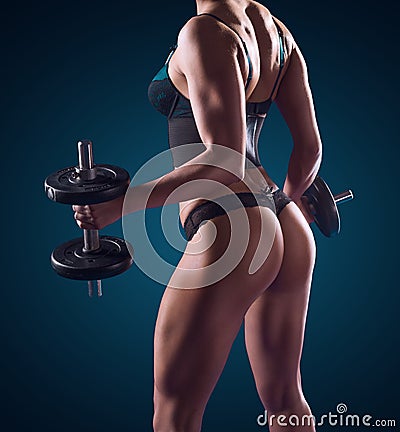 Muscular athletic woman working out with weights