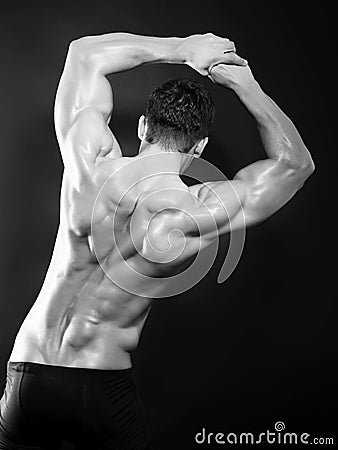 Muscular male back in black in white