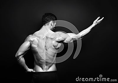 Muscular male back in black in white