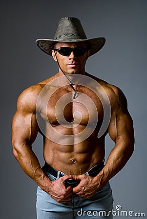 Muscular male in a hat and sunglasses
