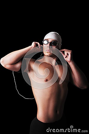 Muscular male swimmer with full equipment listening the music