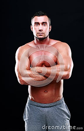 Muscular man with arms folded