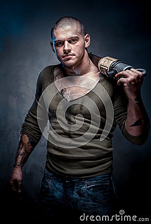 Muscular tattooed man with jackhammer