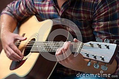 Musician playing acoustic guitar