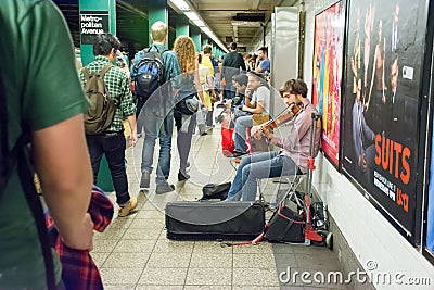 Musician playing violin in a subway in New York City