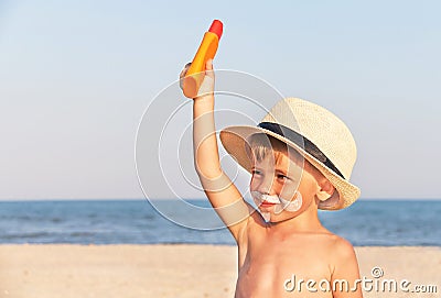 The mustache drawing sunscreen on baby (boy) face.