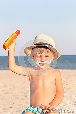 The mustache drawing sunscreen on baby (boy) face.