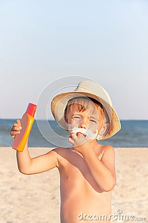 The mustache drawing sunscreen on baby (boy) face.