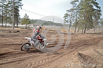 MX racer on the motorcycle accelerates on a straight section san