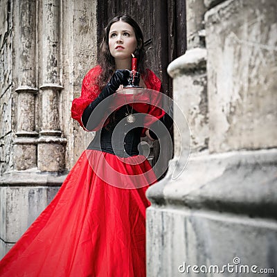 Mysterious woman in red Victorian dress