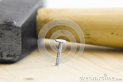 Nail in wood and Hammer