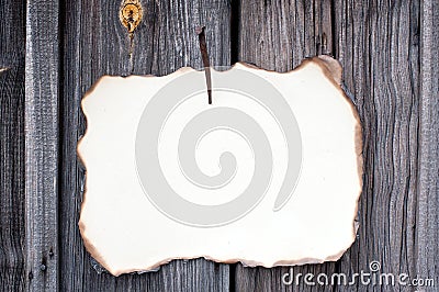 Nailed sheet of paper at wooden wall