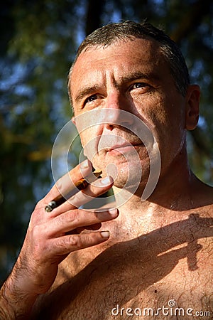 Naked man with a cigar