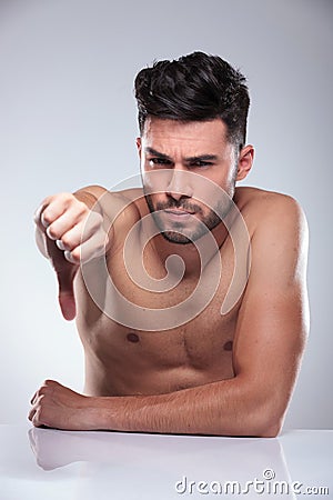 Naked man making the thumbs down sign
