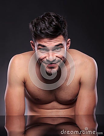 Naked young man smiles at you