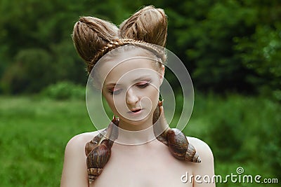 Naked young woman with fashion hairstyle and two big snails