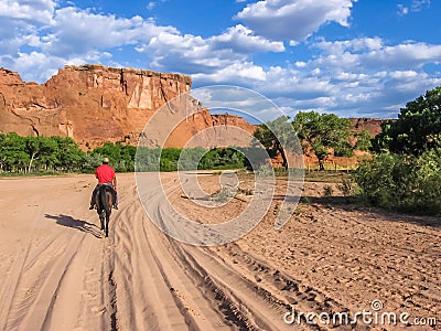 Navajo Indian rides in the valley of Canyon de Chelly