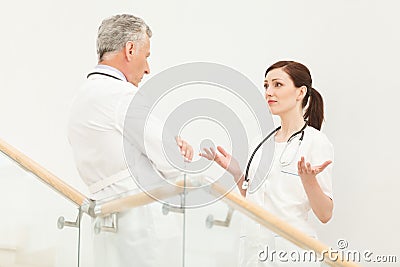 She needs a professional advice. Mature doctor listening to his