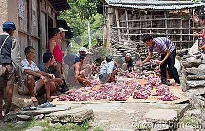 Nepalese who cutting yak or buffalo meat.