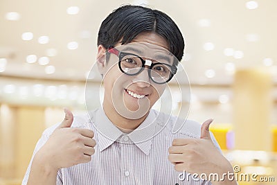 Nerdy Man with Glasses Giving Thumbs Up, Looking At Camera