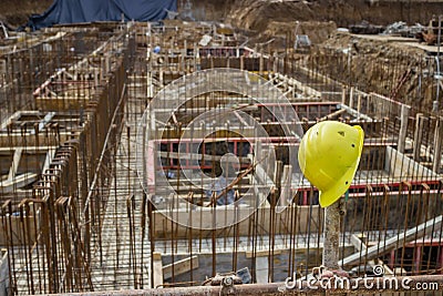 New foundation and steel reinforcement rods with yellow hard hat
