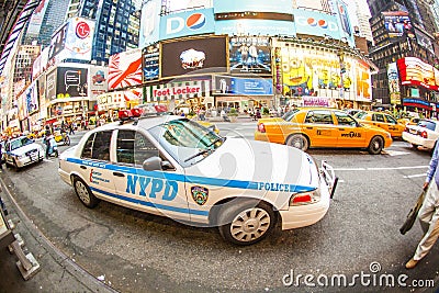 Times square in New York with yellow cabs and Police car