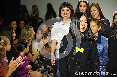 NEW YORK, NY - OCTOBER 18: Designers Hyunjoo Lee (R) and Erica Kim walk the runway with models