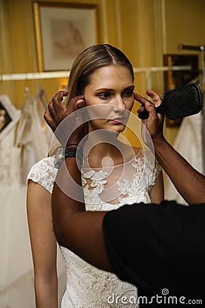 NEW YORK, NY - OCTOBER 09: A model getting ready backstage wearing Oleg Cassini Fall 2015 Bridal collection