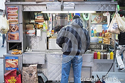 NEW YORK, US - NOVEMBER 24: Street corner food stand with seller