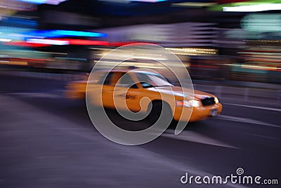 New York yellow cab driving through Times Square