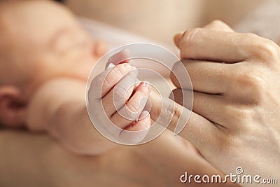 Newborn baby holding mother s hand