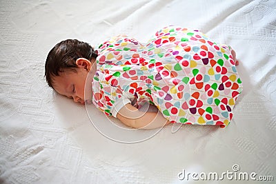 Newborn baby sleeping in fetal position