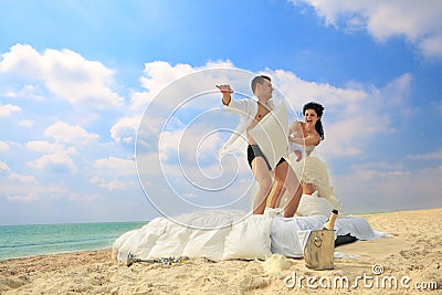 Newlywed couple fighting with pillows