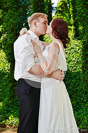 Newlywed couple kiss. Groom bride wedding day love