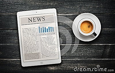 News article on digital tablet and coffee cup