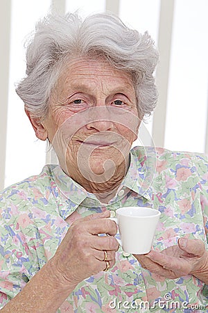 Nice senior ladys portrait with a cup of coffee