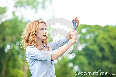 Nice woman taking pictures with smartphone